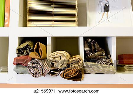Stock Image - Fabrics in Cubby Holes in Work Space. Fotosearch