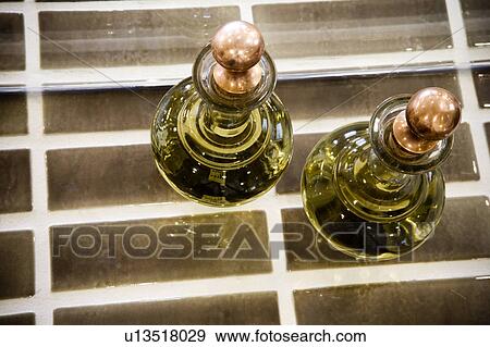 Stock Photo - Fragrance bottles on brown tile. Fotosearch