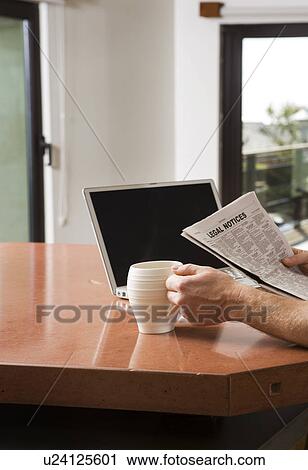 Man Reading Newspaper with Laptop and Coffee View Large Photo Image Stock Image - Man Reading Newspaper with Laptop and Coffee. Fotosearch