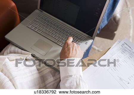 Man Working on Laptop in Modern Living Room View Large Photo Image Stock Image - Man Working on Laptop in Modern Living Room. Fotosearch