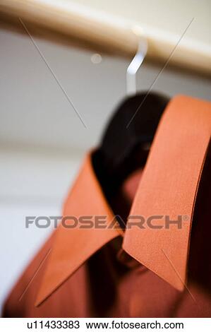 Red Collared Dress Shirt Hanging in Closet View Large Photo Image Stock Image - Red Collared Dress Shirt Hanging in Closet. Fotosearch