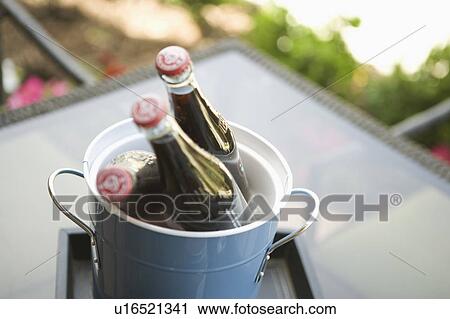 Three cola bottles in an ice bucket View Large Photo Image Stock Image - Three cola bottles in an ice bucket. Fotosearch