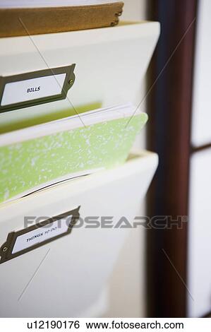Stock Photograph - Wall Mounted File Organizer with Green Notebook. Fotosearch