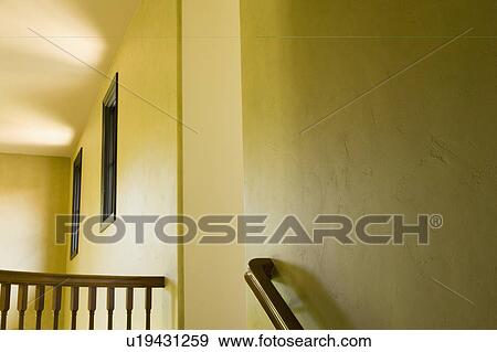 Stock Photo - Staircase railing on yellow wall. Fotosearch