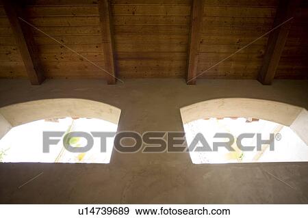 Symmetrical detail of two arches with wood beamed ceiling View Large Photo Image Stock Photo - Symmetrical detail of two arches with wood beamed ceiling. Fotosearch
