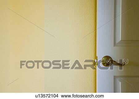 Picture - Open door against yellow wall. Fotosearch