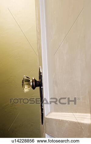 Stock Photograph - Vintage crystal doorknob and yellow Wall. Fotosearch