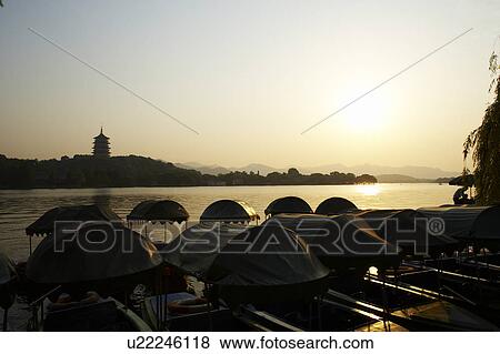 The Six Harmonies Pagoda and small boats, West Lake in Hangzhou, Zhejiang Province, People Republic of China View Large Photo Image Stock Photo - The Six Harmonies Pagoda and small boats, West Lake in Hangzhou, Zhejiang Province, People Republic of China. Fotosearch