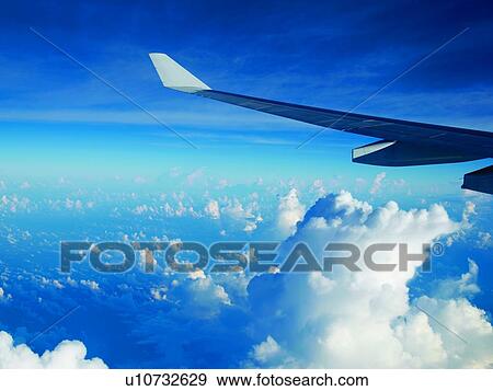 Wing of airplane in flight View Large Photo Image Stock Photo - Wing of airplane in flight. Fotosearch