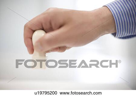 Stock Image - Affixing a seal to document. Fotosearch