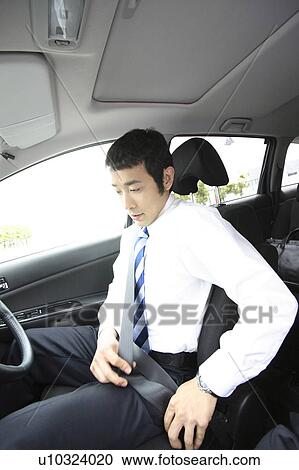 Stock Image - Businessman driving a car. Fotosearch