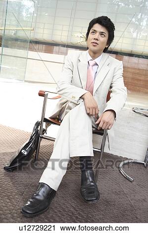 Businessman sitting a chair View Large Photo Image Stock Image - Businessman sitting a chair. Fotosearch