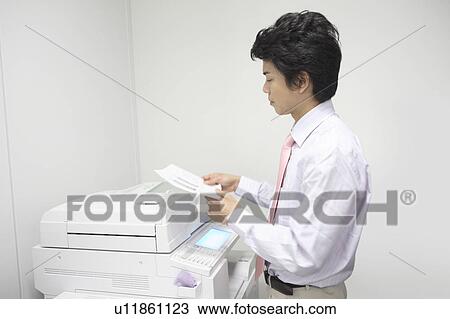 Stock Image - Businessman taking the copy. Fotosearch