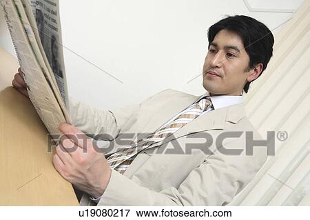 Office worker who reads a newspaper View Large Photo Image Stock Photo - Office worker who reads a newspaper. Fotosearch