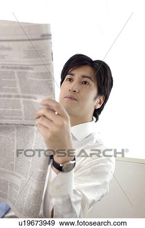Office worker who reads a newspaper View Large Photo Image Stock Photo - Office worker who reads a newspaper. Fotosearch