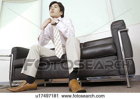Office worker who sits on the chair View Large Photo Image Stock Image - Office worker who sits on the chair. Fotosearch