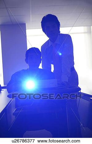 Projector and a businessman View Large Photo Image Stock Photo - Projector and a businessman. Fotosearch