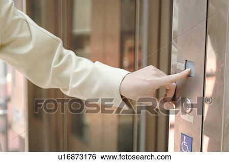 Woman who pushes a button View Large Photo Image Stock Photograph - Woman who pushes a button. Fotosearch