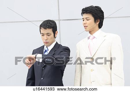 Busineeman watching a wristwatch View Large Photo Image Stock Image - Busineeman watching a wristwatch. Fotosearch
