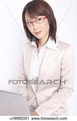 Business lady operating a laptop computer View Large Photo Image Stock Image - Business lady operating a laptop computer. Fotosearch