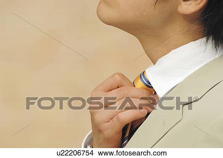 businessman putting on a necktie View Large Photo Image Picture - businessman putting on a necktie. Fotosearch