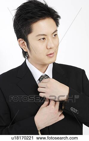 businessman putting on a necktie View Large Photo Image Stock Image - businessman putting on a necktie. Fotosearch