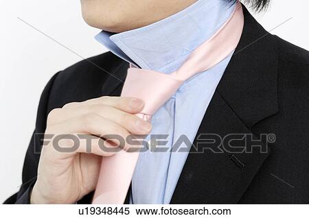 businessman putting on a necktie View Large Photo Image Stock Photography - businessman putting on a necktie. Fotosearch
