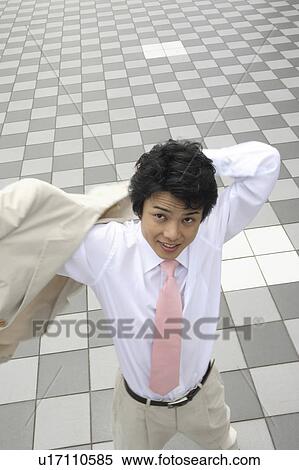 Stock Photography - Businessman putting on a suit. Fotosearch