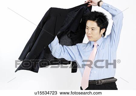 Businessman putting on the jacket of the suit View Large Photo Image Stock Image - Businessman putting on the jacket of the suit. Fotosearch