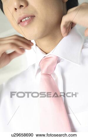 Businessman straightening up neck View Large Photo Image Stock Image - Businessman straightening up neck. Fotosearch
