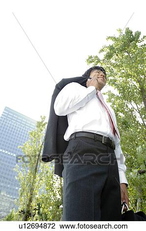 Businessman with a jacket over a shoulder View Large Photo Image Stock Image - Businessman with a jacket over a shoulder. Fotosearch