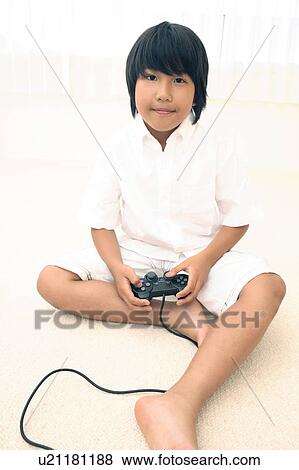 Stock Photo - Boy playing the game. Fotosearch