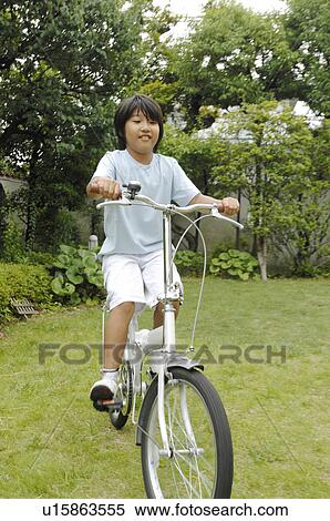 Boy who takes a bicycle View Large Photo Image Stock Photography - Boy who takes a bicycle. Fotosearch
