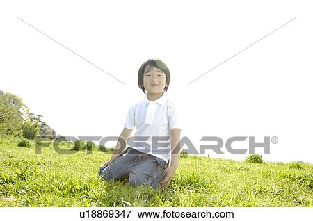 Stock Photo - Child on the grassland. Fotosearch