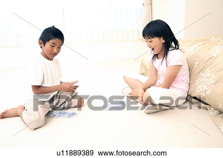 Stock Photo - Children playing cards. Fotosearch