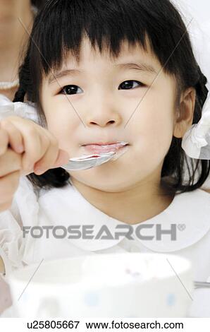 Girl eating a meal View Large Photo Image Stock Photo - Girl eating a meal. Fotosearch