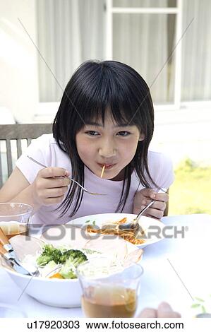 Girl eating pasta View Large Photo Image Stock Image - Girl eating pasta. Fotosearch