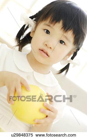 Stock Photography - Girl having a grapefruit. Fotosearch