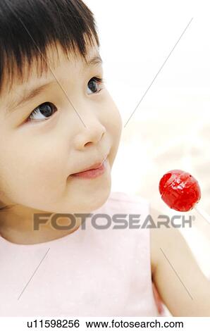 Stock Photograph - Girl having candy. Fotosearch