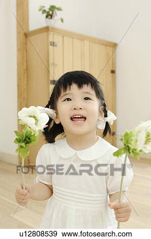 Girl having flower View Large Photo Image Stock Photo - Girl having flower. Fotosearch