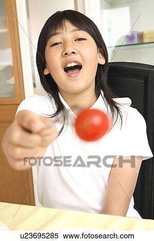 Girl holding out a tomato View Large Photo Image Stock Photography - Girl holding out a tomato. Fotosearch