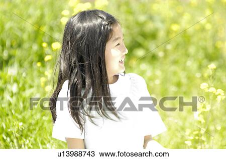 Stock Image - Girl on the grassland. Fotosearch