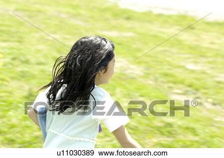 Girl running grassland View Large Photo Image Stock Photo - Girl running grassland. Fotosearch
