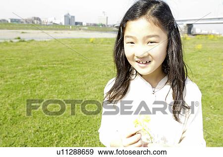 Girl who plays at the shore of the river View Large Photo Image Stock Photo - Girl who plays at the shore of the river. Fotosearch