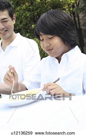 Stock Photo - Parent and child eating a meal. Fotosearch