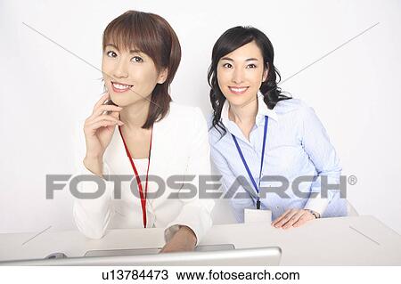 Business lady and the fellow worker who sit down before a laptop computer View Large Photo Image Stock Image - Business lady and the fellow worker who sit down before a laptop computer. Fotosearch