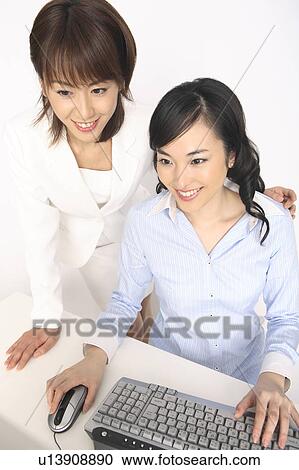 Stock Image - Business lady operating a PC. Fotosearch