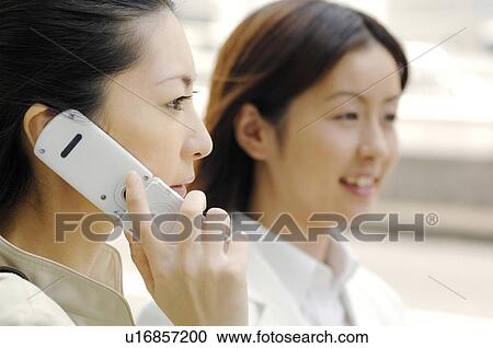 Stock Image - Business lady who speaks with the cell phone. Fotosearch