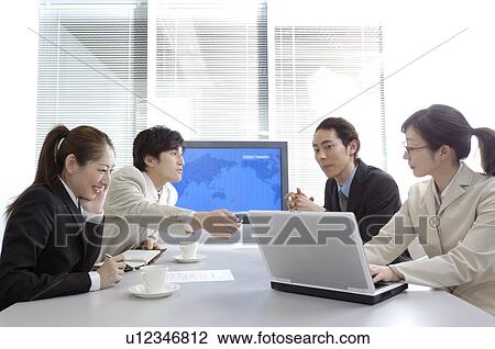 Stock Image - Business people during conference. Fotosearch