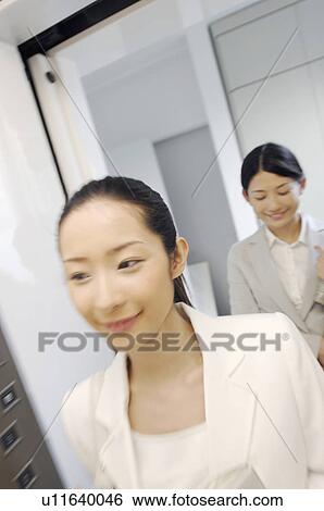 Woman who boards an elevator View Large Photo Image Stock Photograph - Woman who boards an elevator. Fotosearch